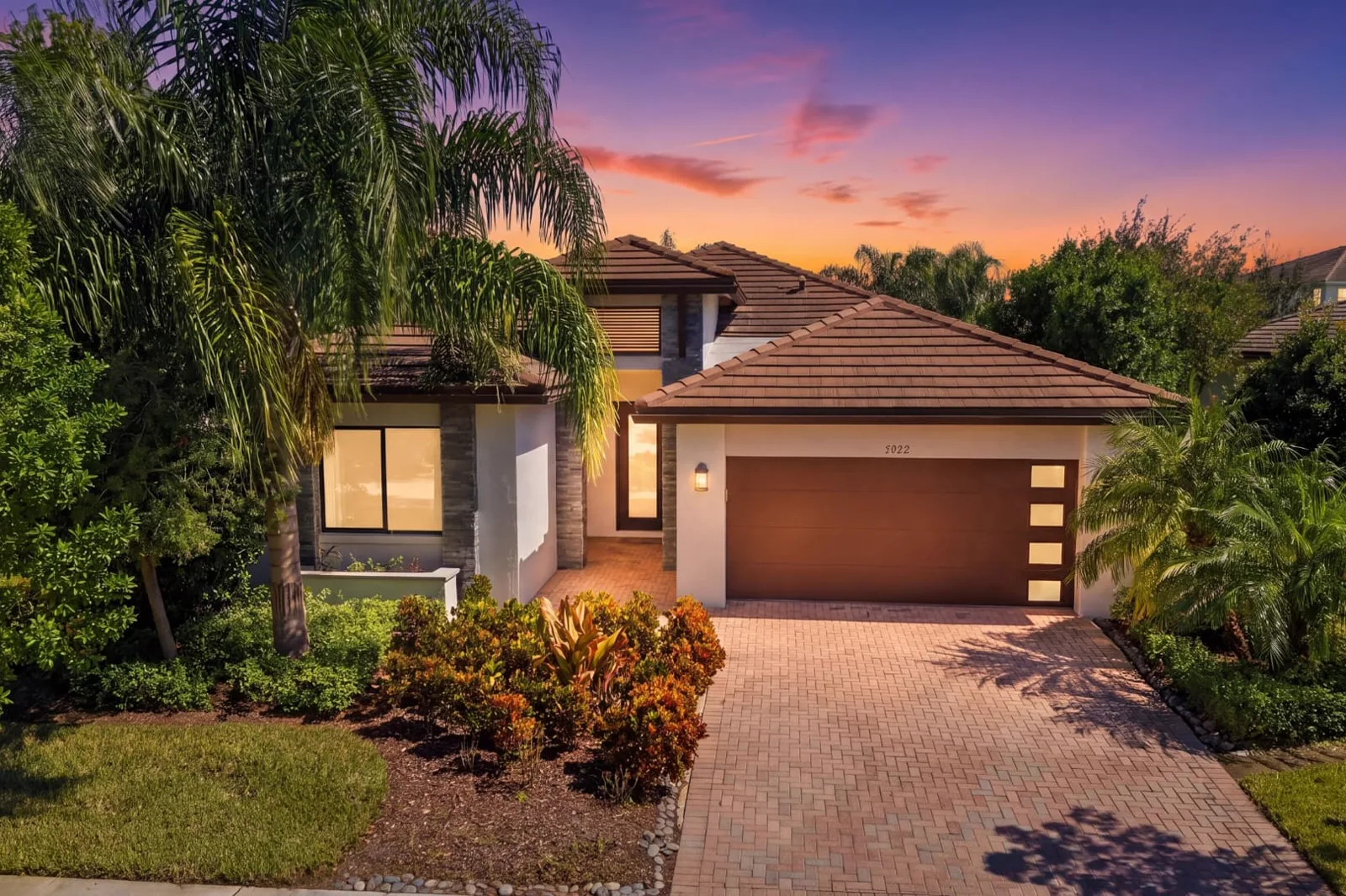 The same home converted to a sunset sky with warm glowing windows