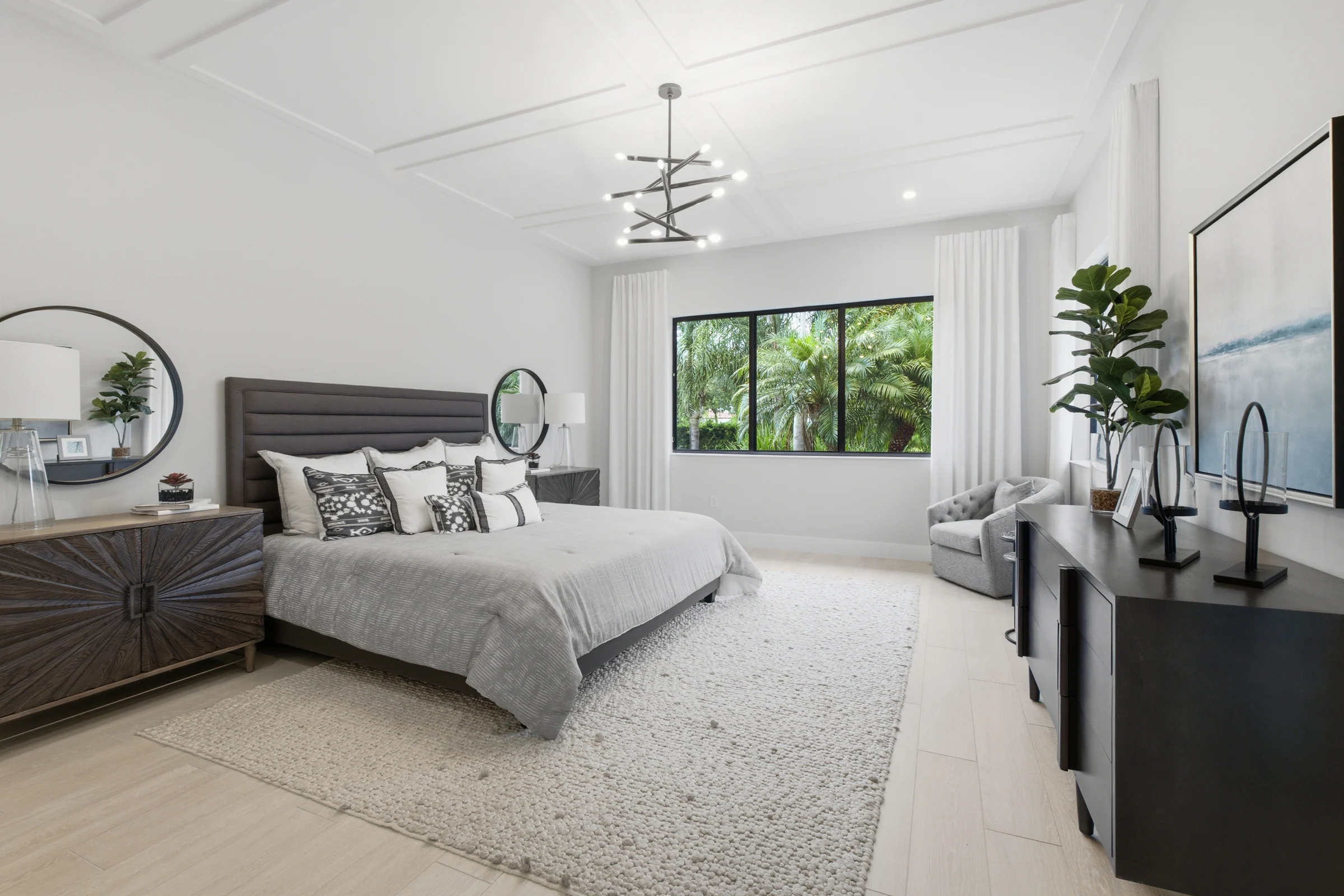 Primary bedroom with an upholstered headboard and coffered ceiling