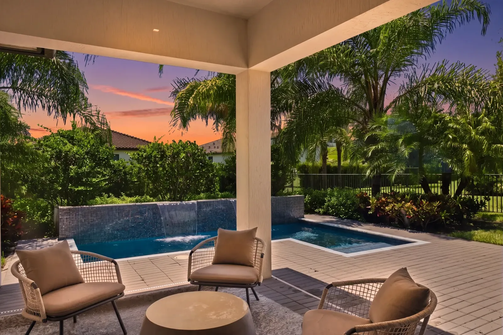 Covered patio and plunge pool beneath a twilight sky (virtual twilight, digitally enhanced)