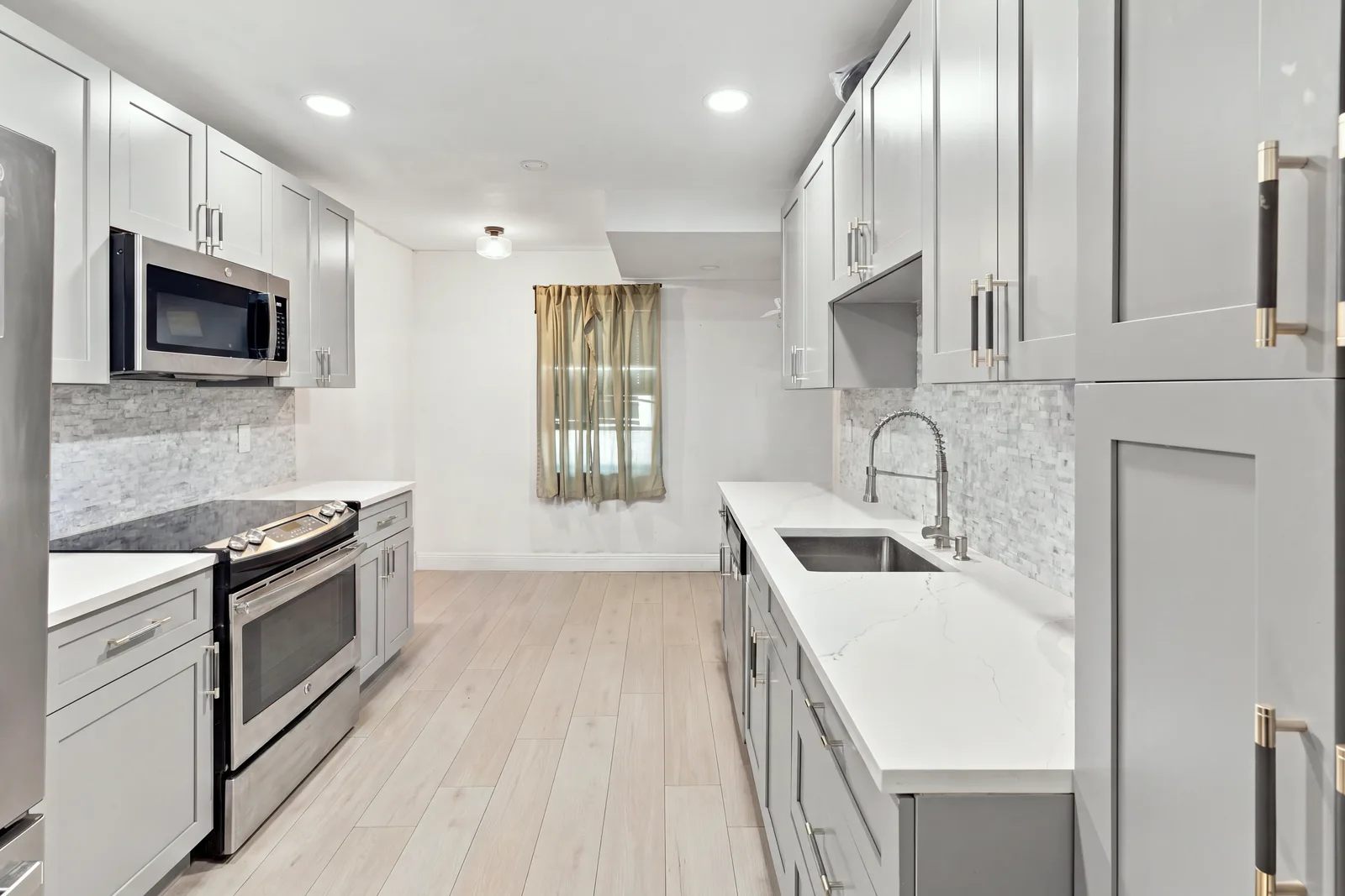 The same kitchen with counters and floor cleared of personal items