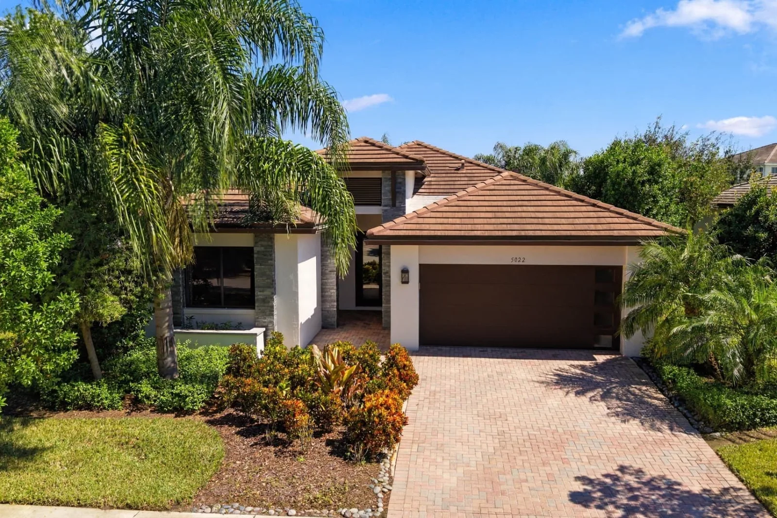 Front exterior of a single-story South Florida home photographed in daylight