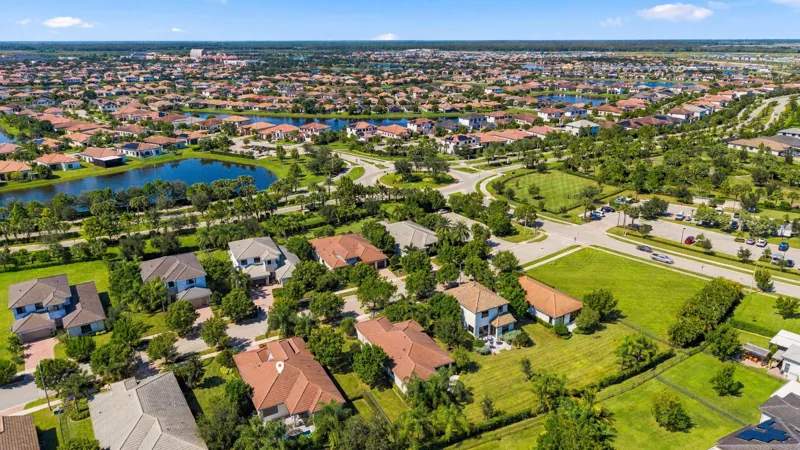 Aerial view over the neighborhood and lake with a pin marking the Fairmont model home