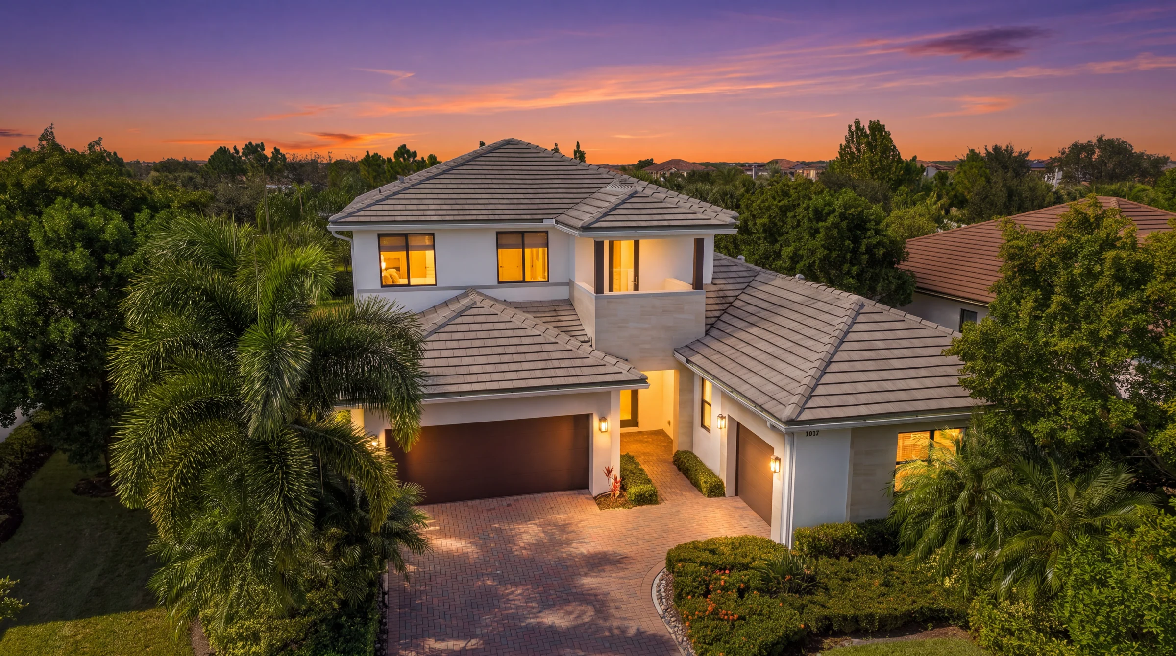 Elevated view of the Harbour model home at sunset (virtual twilight, digitally enhanced)