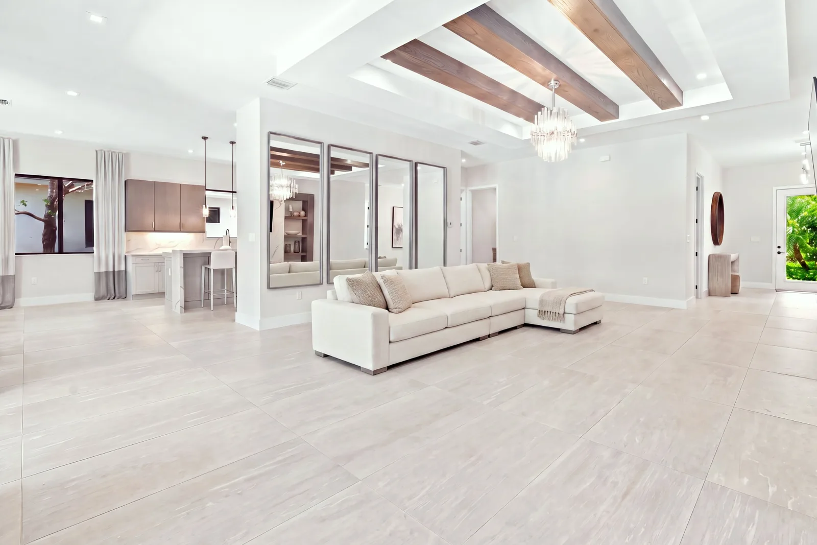 Open living room with a single sectional sofa, before virtual staging