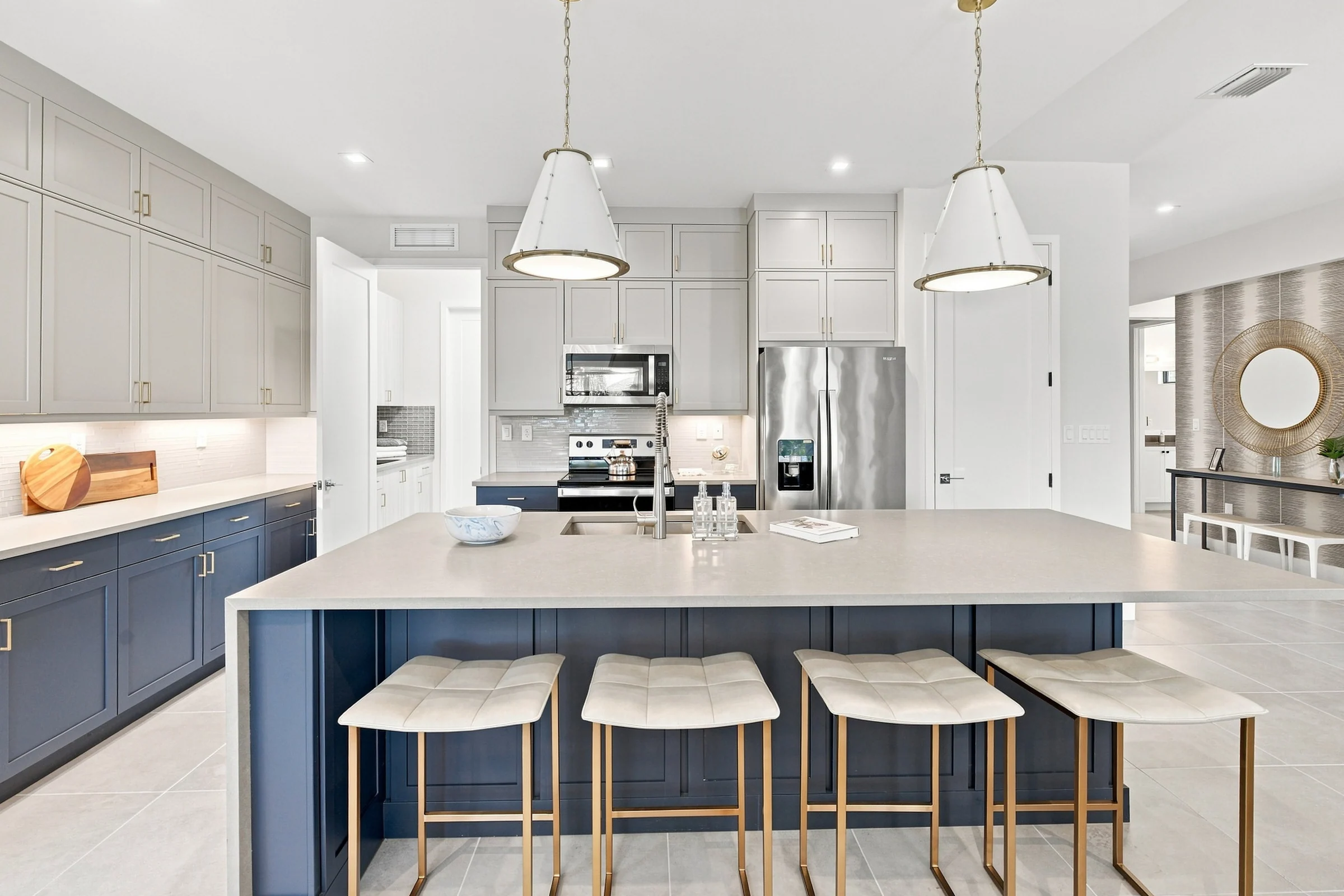 Kitchen island with four counter stools and pendant lights
