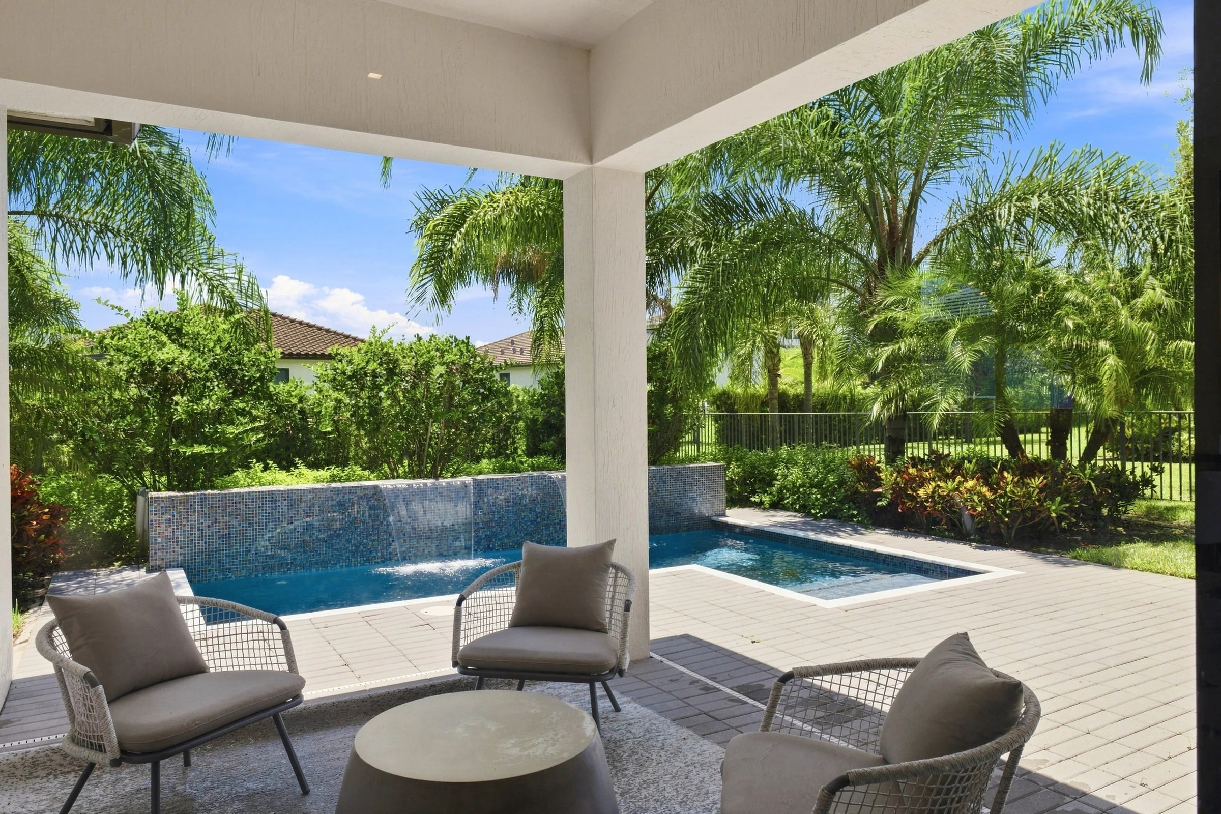 Covered patio with lounge chairs overlooking a plunge pool
