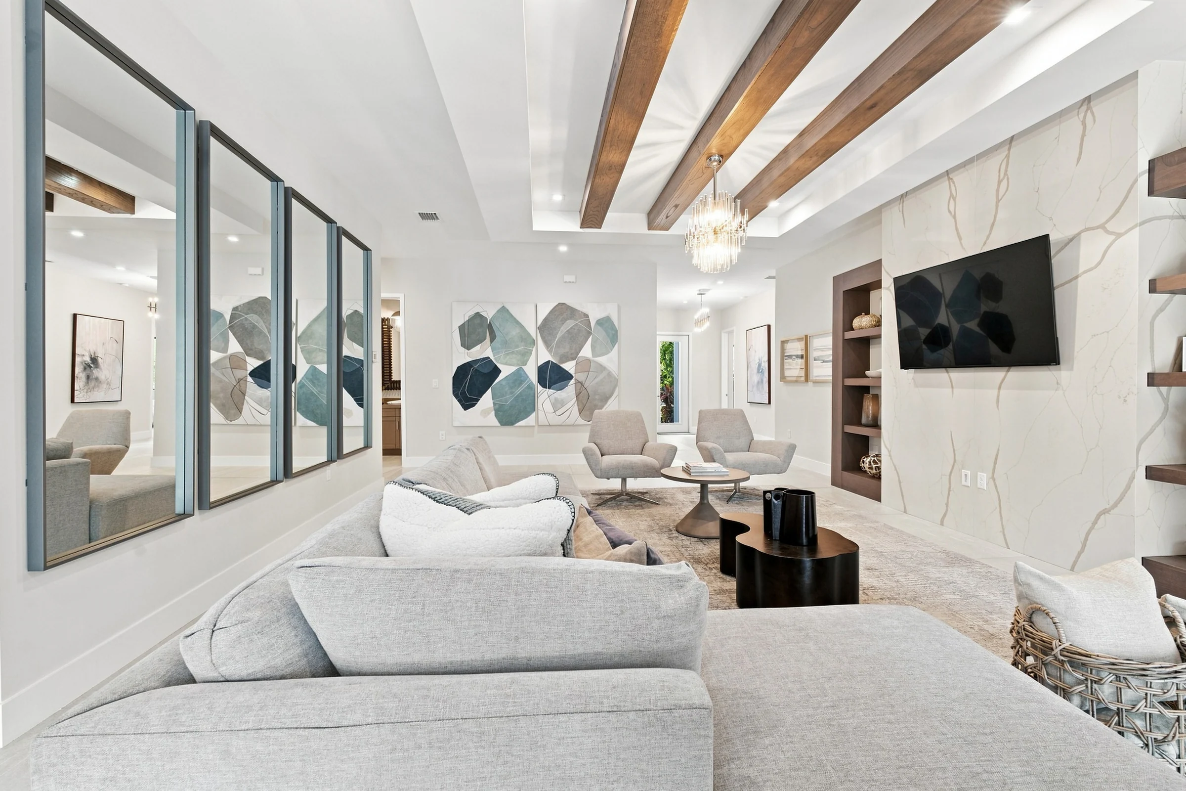 Family room with a wall-mounted TV and mirrored panels