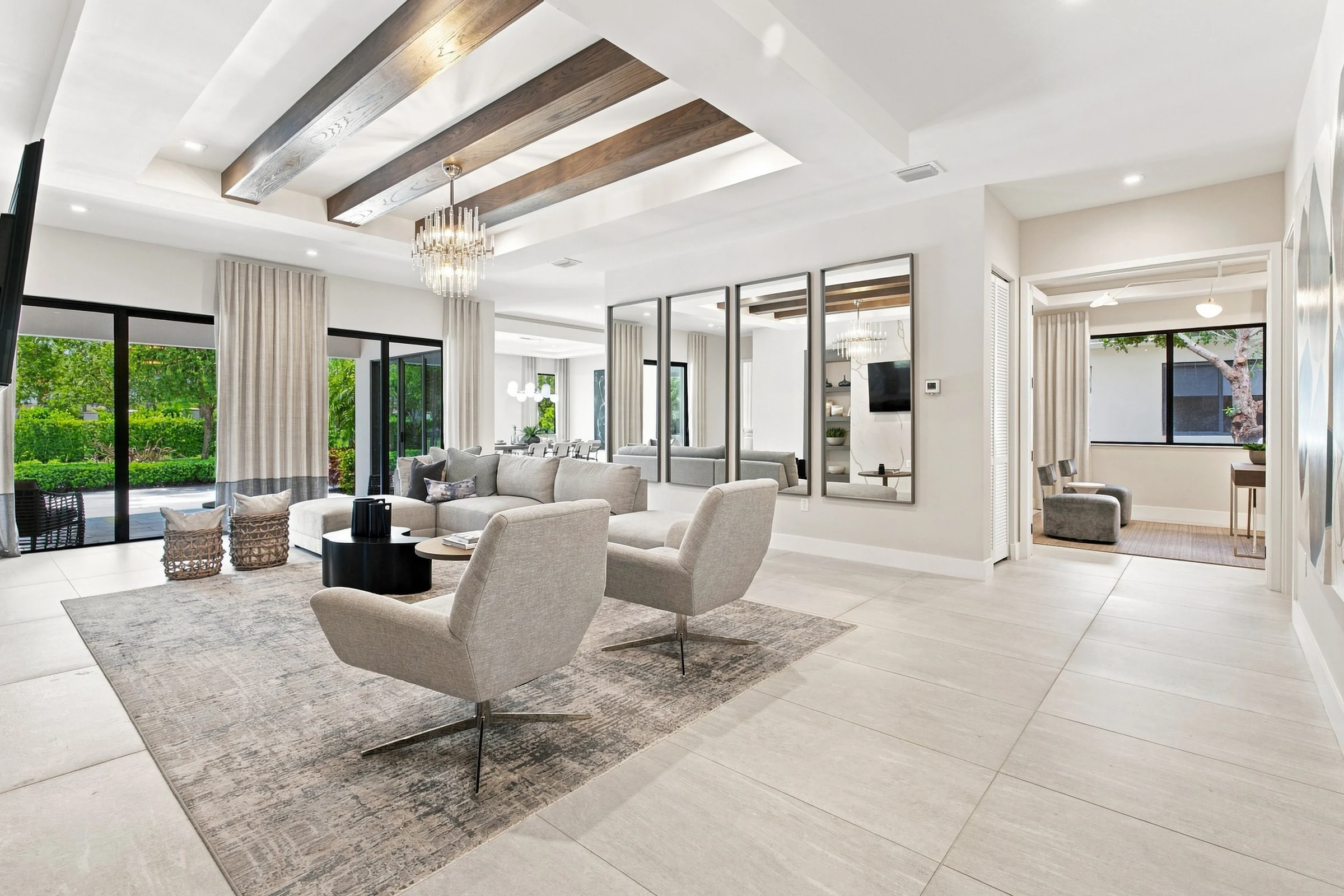 Great room with wood ceiling beams and swivel chairs