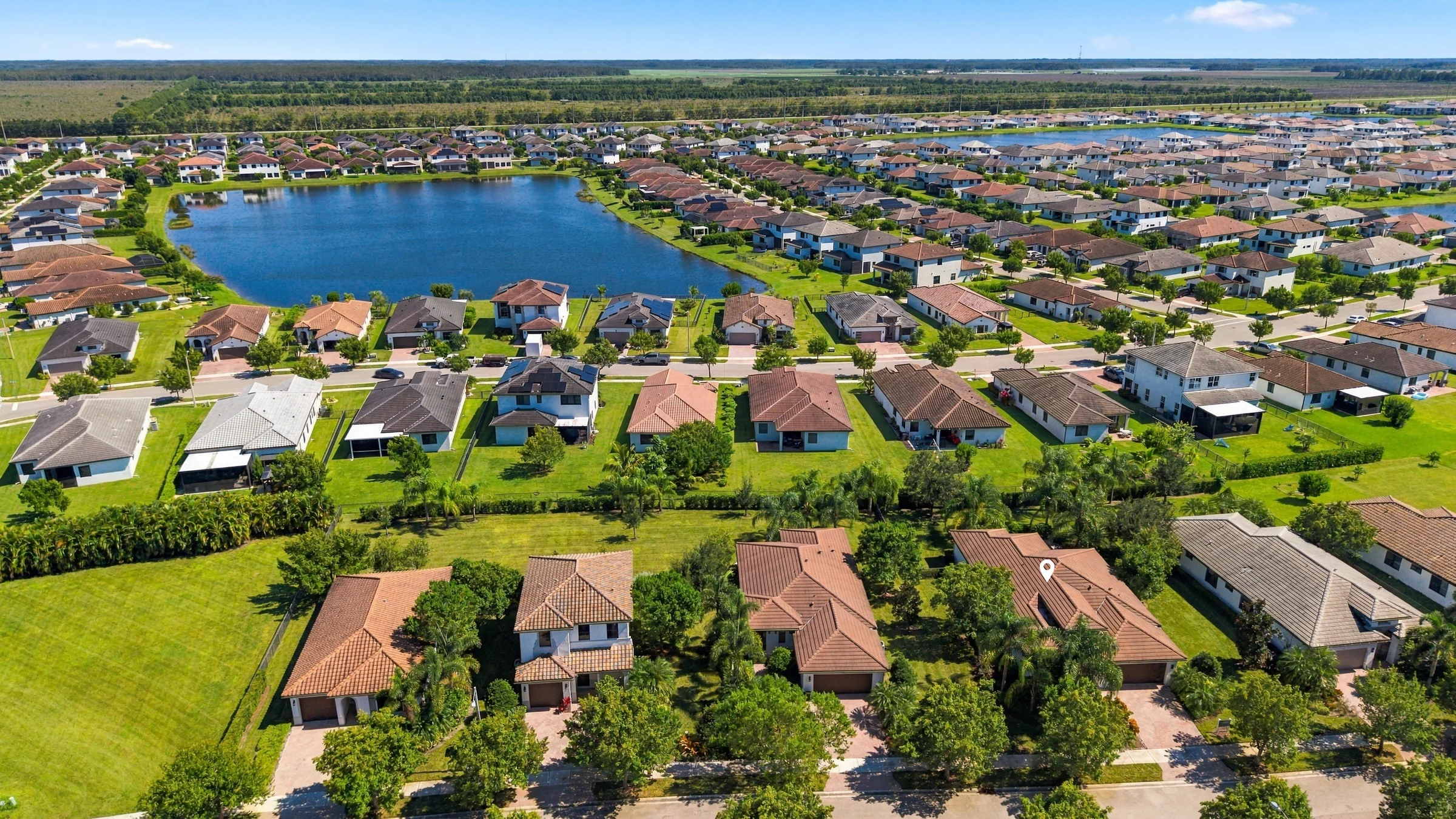 Aerial view from behind the home toward the lake with a pin marking the Fairmont model home